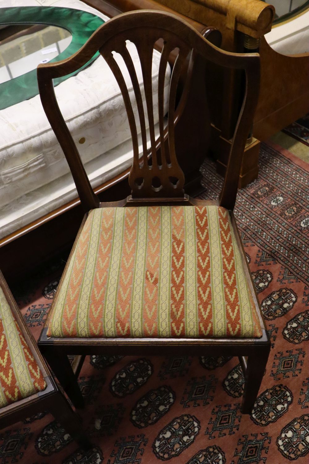 A set of four Hepplewhite style dining chairs (3 single, 1 arm) and four Edwardian dining chairs